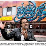 Salim Ahmad of the Muslim Canadian Congress who has initiated a petition to Mayor Rob Ford of Toronto asking that the jihadi mural behind him in this picture, be removed.